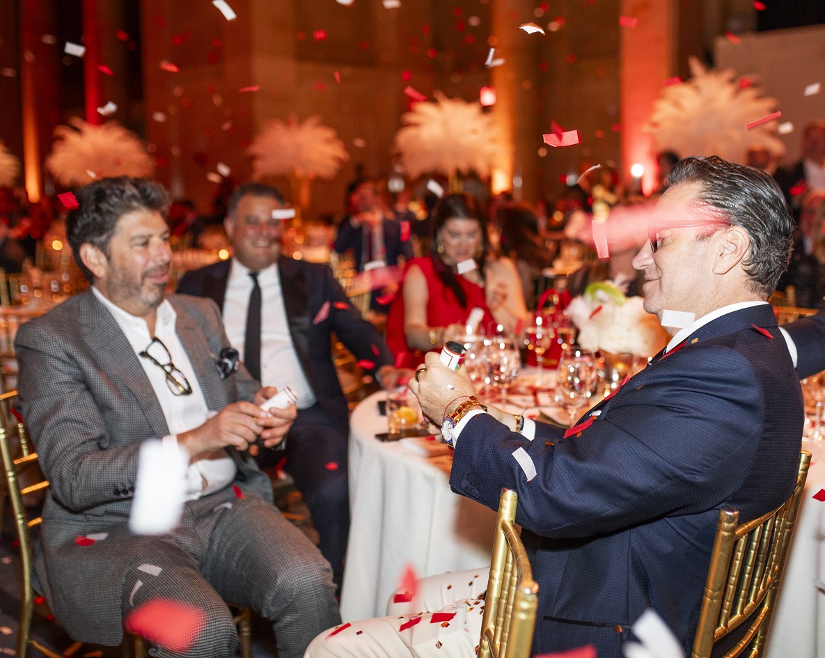 Table of attendees with confetti falling around them